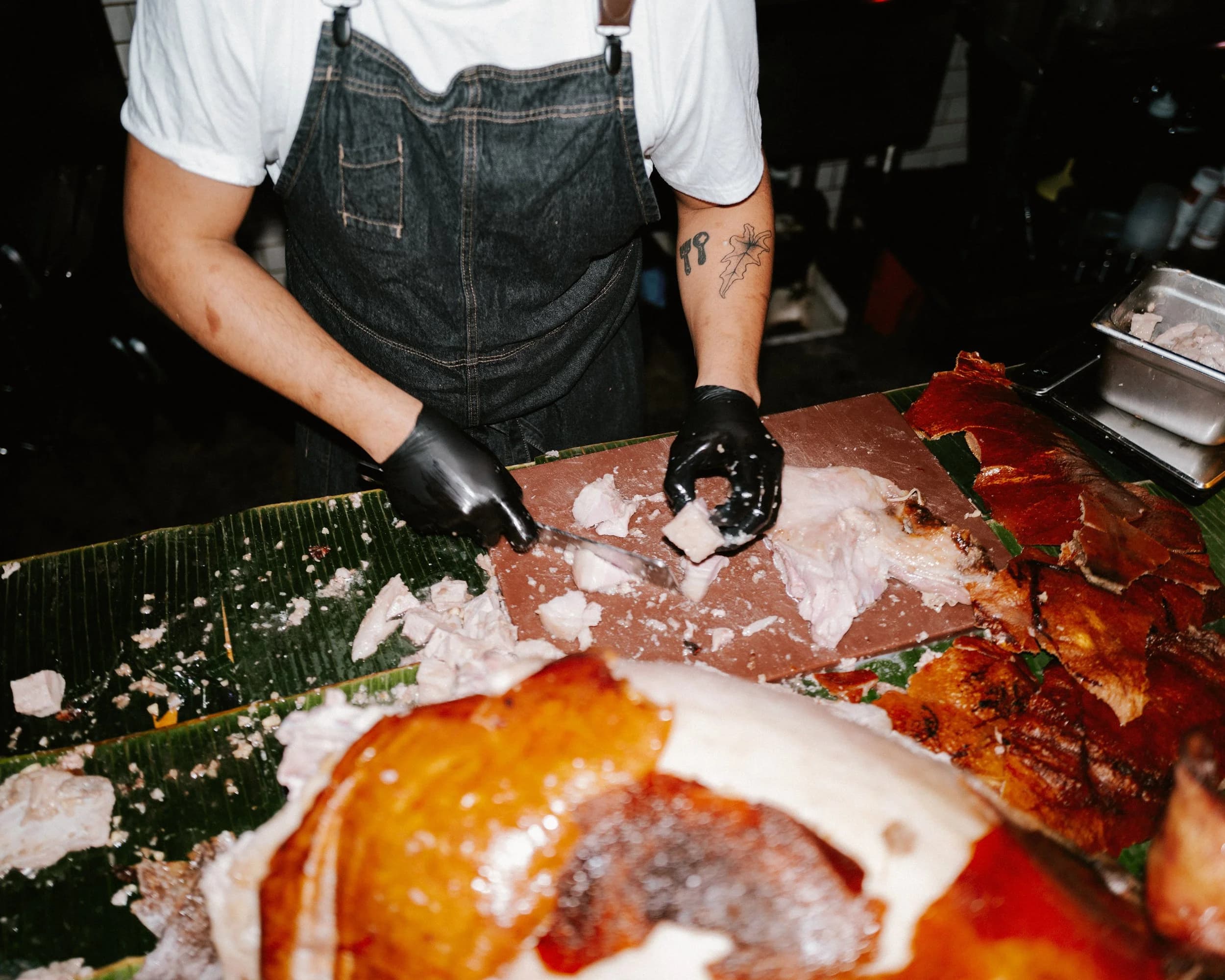 Chef TJ Cruz preparing lechon at the 5-year anniversary celebration